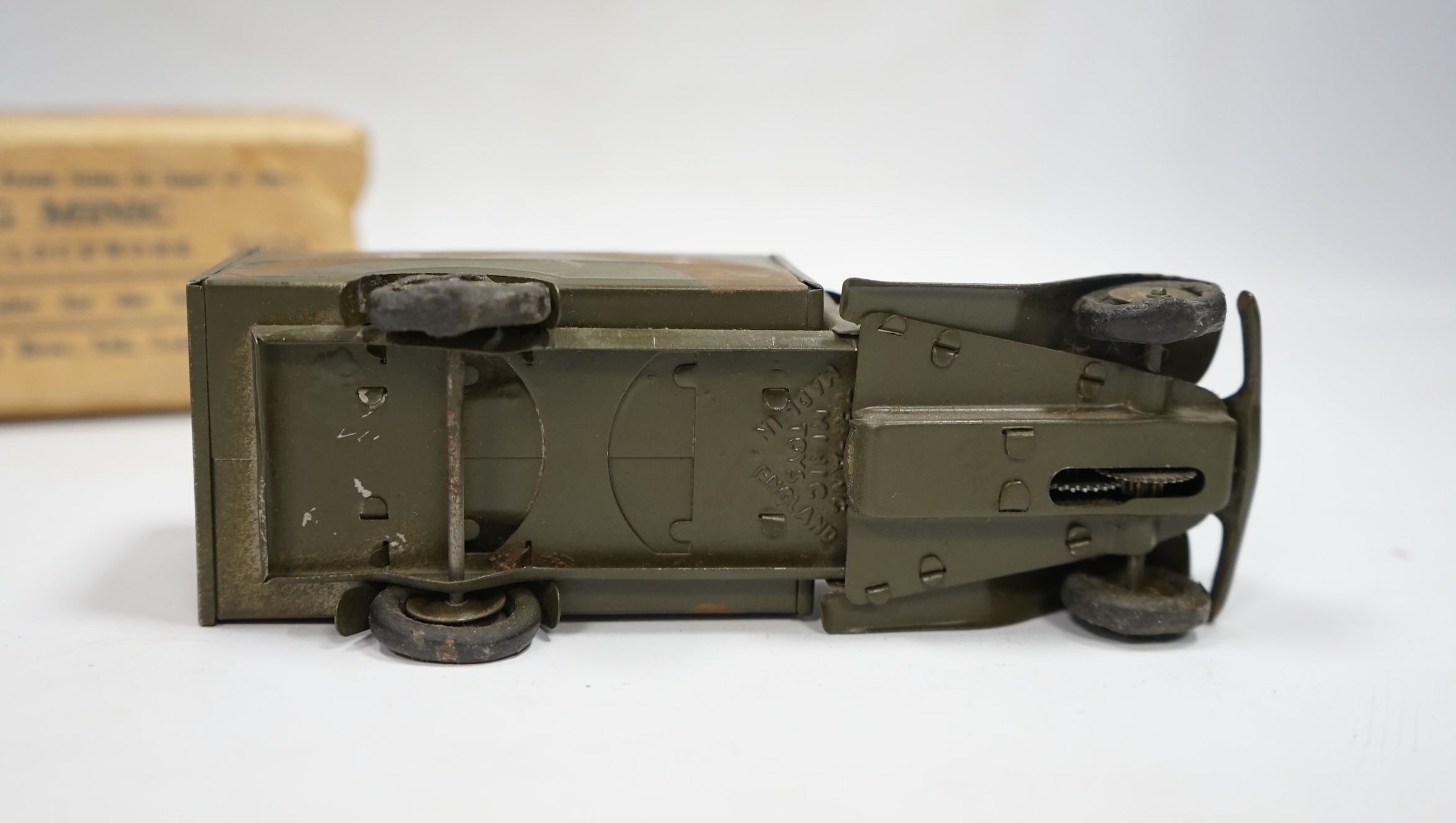 A Tri-ang Minic clockwork tinplate army lorry, in camouflage paint work, together with the remains of its box. Condition fair, original tires fatigued as expected, the box with missing flaps.